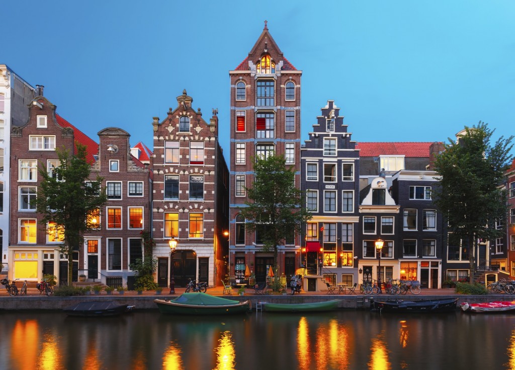 Night city view of Amsterdam canal with dutch houses