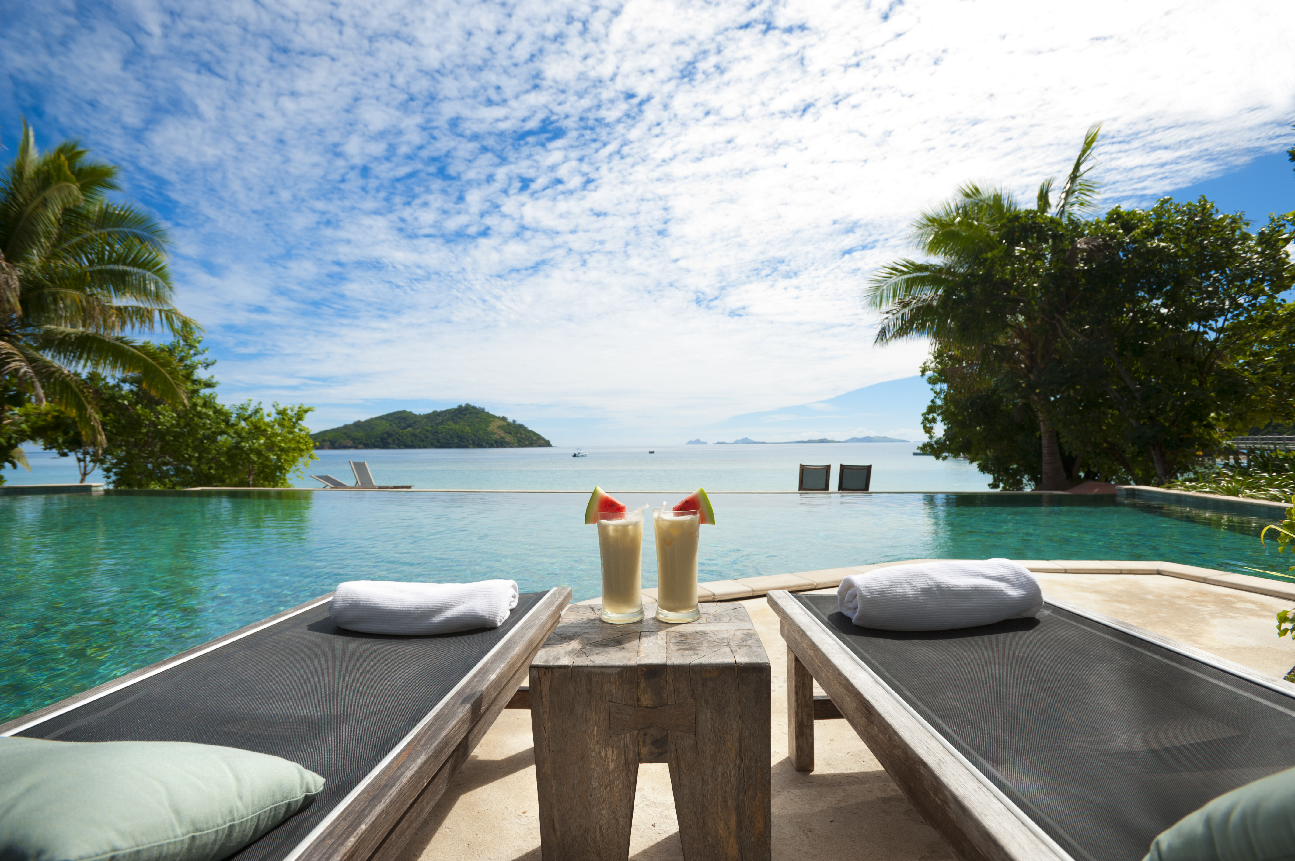 Sun lounges and cocktails by the pool in a tourist resort